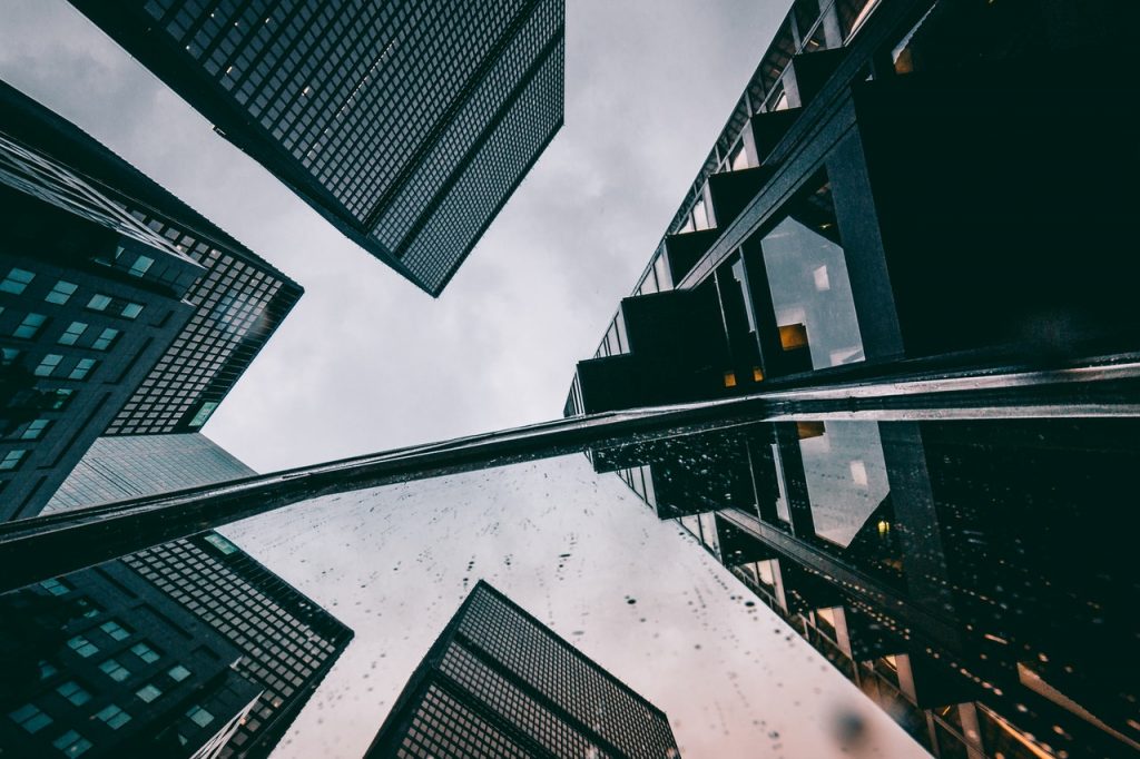 Buildings in city, with rain on a closeup window pane