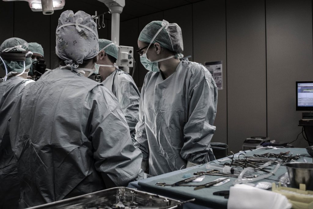 Healthcare doctors in surgery room with masks and scrubs